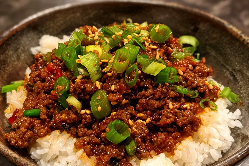Chef sautéing beef in a skillet for Savory Korean Beef Rice Bowl, showcasing the cooking process.