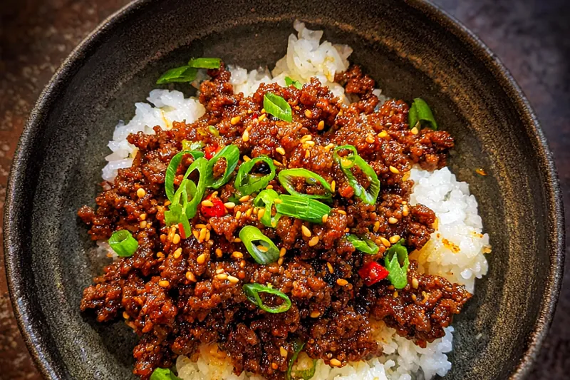 An organized spread of fresh ingredients for Savory Korean Beef Rice Bowl including beef, rice, and vegetables.